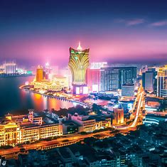 Create an image of Macau at night, showcasing its vibrant skyline and city lights.