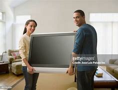 Image result for Man Carrying to Large Flat Screen TV