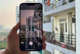 Image result for Image of a Person Taking Photo with iPhone 14