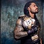Image result for Roman Reigns Holding Titles
