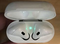 Image result for Air Pods While Charging the Case with Light