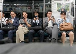 Image result for People On Their Phone On a Train