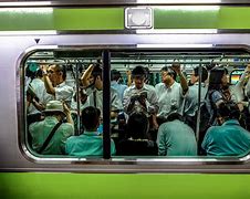 Image result for People in Tokyo Fighting to Get On the Train