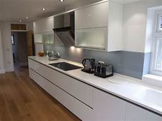 corian wood high gloss white cabinetry with antarctica corian tops corian wood high gloss white cabinetry with antarctica corian tops