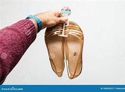 Image result for Person Holding a Pair of Crocs