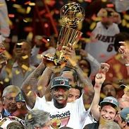 Image result for LeBron James Miami Heat Holding Trophy
