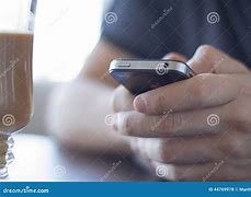 Image result for Man Holding iPhone SE