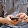 Image result for Man Holding Mobile Phone