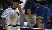 Don Mattingly helps himself to a young fan's popcorn
