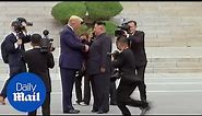 Moment Trump steps into North Korea to meet Kim Jong-un