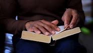 Premium stock video - Black man holding the holy bible after praying in church stock footage