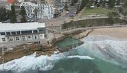 People Swim At Ross Jones Rock Pool With Crashing Sea Waves - Coogee Beach And Coogee Surf Life Saving Club Facility In NSW, Australia. - aerial