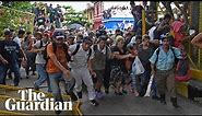 Migrant caravan in Guatemala breaks through border fence into Mexico