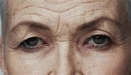 Portrait of Old Woman Face with Eyes Wide Open Looking at Camera Close Up. Serious Vision of One Aging Adult with Older Features. Modern Concept of Good Sighted Mature Person Thinking on Retirement