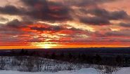 Fiery sunset captured over snowy landscape