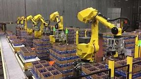 Automated Decasing System Uses Six FANUC Robots to Decase Bottles - StrongPoint Automation
