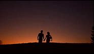 guy and girl walking holding hands loving couple walk on sunset background silhouette of loving coup