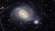 Spiral Galaxy Arm Wraps Around Companion In Amazing Imagery