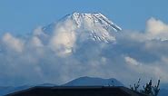 Snow-capped Mt. Fuji emerges after rain: a time-lapse view