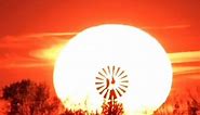 Amazing sun sets behind windmill in Minnesota