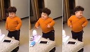 Cute Chinese toddler enjoys having a dance to disco music