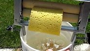Best hand clothes wringer demonstrating wringing out sponges while attached to 5 gal bucket