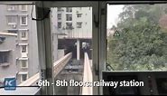 Watch: This train passes through residential building in China!