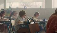 Students Sitting at Desks in School Class