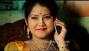 Manipuri bride speaks to friends on her mobile, before her wedding