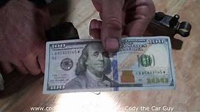 How to spot a fake 100 dollar bill