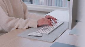Premium stock video - Hands of a female freelancer at home typing on wireless computer keyboard on the table