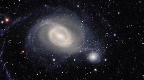 Spiral Galaxy Arm Wraps Around Companion In Amazing Imagery