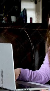 solve tasks exam answer questions online serious stern face of teenage girl with laptop in hands sit on couch lean on arm solve problems