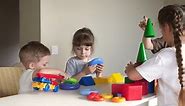 kindergarten. a group of children play toys cubes and cars on the table in indoor kindergarten. kid dream creative happy family preschool education concept. nursery baby toddler home