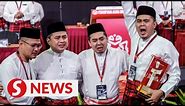 Teary start to Umno Youth meet for Najib's sons as they receive award on his behalf
