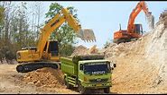 Excavator Dump Truck Digging Limestone On Road Construction Kobelco SK200 Komatsu PC200