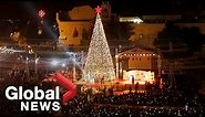 Hundreds gather for Christmas tree lighting ceremony in Bethlehem to mark start of festive season