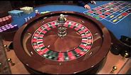 Roulette Wheel Spinning in Las Vegas Casino the Dealer Croupier Rims the ball and Marks Winning Spot
