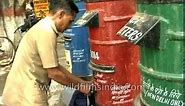 Indian Postman empties a letter box - archival footage of the daakiya