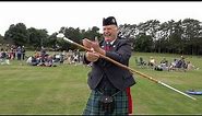 Drum Major Bill Barclay demonstrates the skill of the Mace Flourish during Ballater Games in 2021