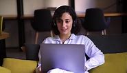 Free stock video - Portrait of curly, brunette woman working on laptop at home office