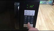 Setting time on an Oster OGZJ1104 1100w microwave . Easy