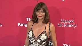 Helena Christensen dips in a freezing lake in a plunging swimsuit