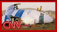 1988 footage shows Pan Am Flight 103 wreckage. The bombing suspect is now in US custody