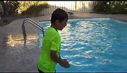 Maxwell swims in clothes and shoes to prove he is safe around pools