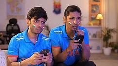 Two young brothers checking the live cricket score - placing online bets, Indian cricket teams, sports app, online gaming addiction . Indian men watching online live cricket match on an app, cricke...