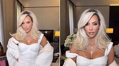 Kim Kardashian is heavenly in white mini dress & matching coat