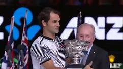 Rod Laver presents Roger Federer with the trophy