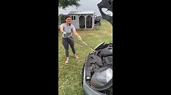 Nicole Graham removes a snake from her daughter's car in Burton, Texas (Courtesy of Nicole Graham)