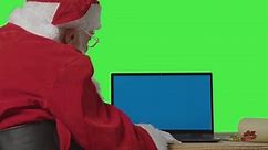 Over the Shoulder Shot of Santa Using Blue Screen Laptop.